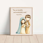 Framed artwork of the Holy Family with a quote on a white wall.